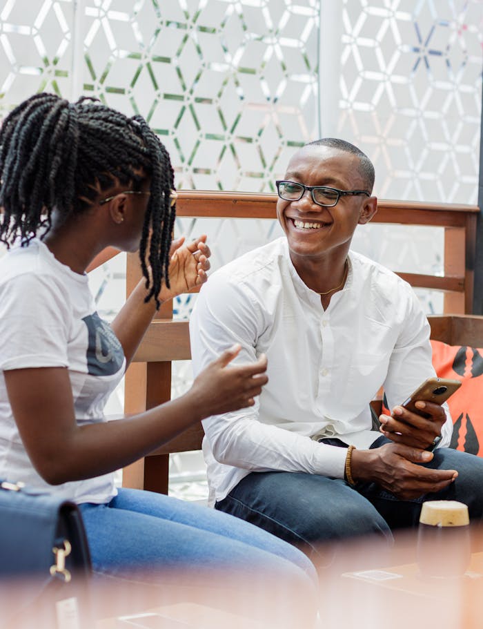 services-03 Happy couple having a lively conversation over coffee in a stylish outdoor café in Accra, Ghana.