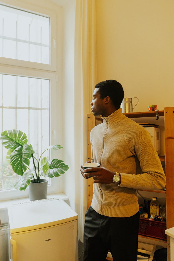 Crafting Captivating Headlines: Your awesome post title goes here A man enjoys a quiet morning with coffee in a Berlin apartment, embracing a warm and cozy atmosphere.